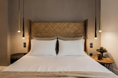 a bedroom with a large bed with two white pillows at *** Boutique Syntagma apartment w/ plunge pool *** in Athens