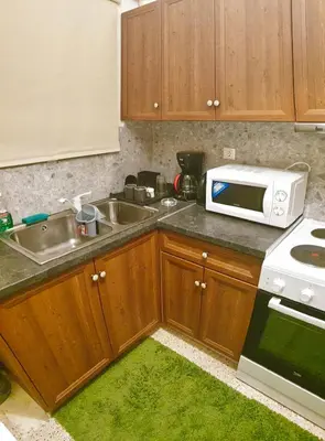 a kitchen with a sink and a microwave at Alexandra's path in Athens