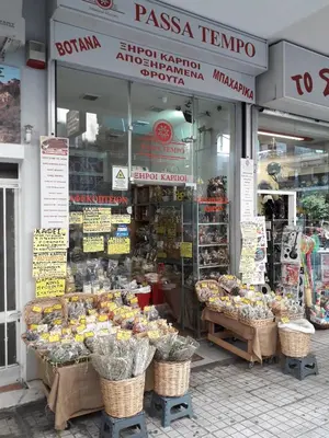 a store front of a store with baskets of food at Alexandra's path in Athens