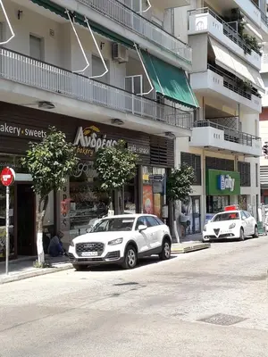 two cars parked in front of a building at Alexandra's path in Athens