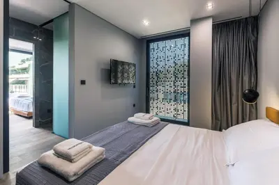 a bedroom with a large bed with towels on it at The Duke Boutique Suites in Athens