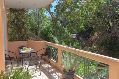 a balcony with a table and chairs and trees at L9 Athens in Athens