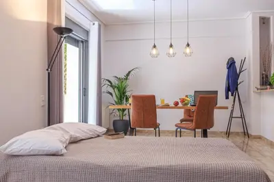 a bedroom with a bed and a table with chairs at L9 Athens in Athens