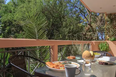 a table with a plate of food on a balcony at L9 Athens in Athens