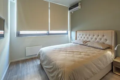 a bedroom with a large bed with a window at THE apartment 2 BDRS/2 BATHS luxury residence in Athens