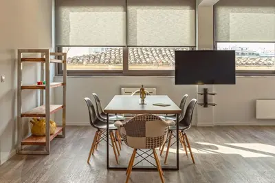 a dining room with a table and chairs and a tv at THE apartment 2 BDRS/2 BATHS luxury residence in Athens