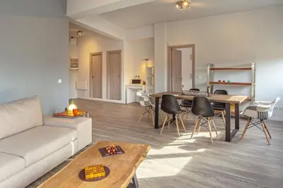 a living room with a couch and a table at THE apartment 2 BDRS/2 BATHS luxury residence in Athens
