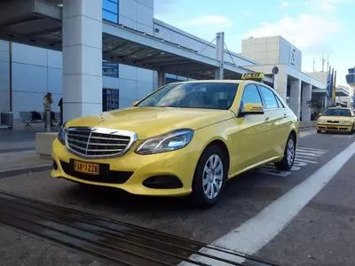 a yellow car parked in a parking lot at THE apartment 2 BDRS/2 BATHS luxury residence in Athens