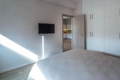 a bedroom with a bed and a tv on a wall at THE apartment 2 BDRS/2 BATHS luxury residence in Athens