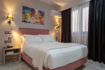 a bedroom with a large bed and a window at Athens Starlight Hotel in Athens