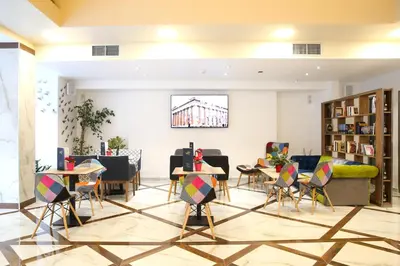 a room with chairs and tables and a building at Athens Starlight Hotel in Athens