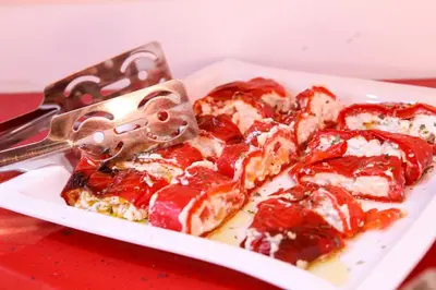 a plate of pepperoni pizza with a pizza cutter at Athens Starlight Hotel in Athens