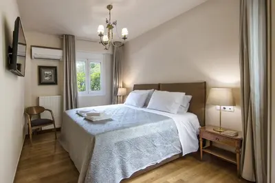 a bedroom with a large bed and a window at 2 bedroom flat next to Acropolis in Athens