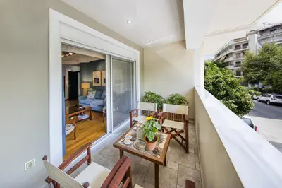 an apartment balcony with a table and chairs at 2 bedroom flat next to Acropolis in Athens