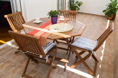 a wooden table with four chairs around it at Acropolis,Historic center Apartment-update in Athens