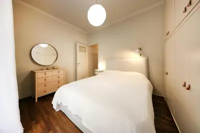 a bedroom with a white bed and a mirror at Brand new Modern Apartment with satellite TV in Athens