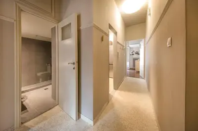 a hallway of a bathroom with a toilet and a tub at Brand new Modern Apartment with satellite TV in Athens