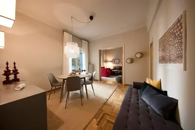 a living room with a couch and a table at Brand new Modern Apartment with satellite TV in Athens