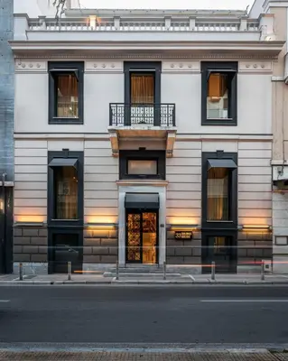 a white building with windows and a balcony at 33SolonosSuites in Athens