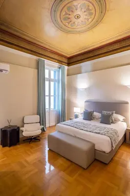 a bedroom with a large bed with a ceiling at 33SolonosSuites in Athens
