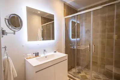 a bathroom with a sink and a shower at 33SolonosSuites in Athens