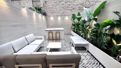 a room with a couch and a table and plants at PINACOTA SUITES ATHENS in Athens