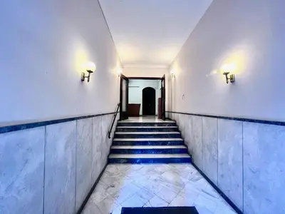 a hallway of a building with stairs and lights at PINACOTA SUITES ATHENS in Athens