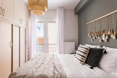 a bedroom with a large white bed with pillows at Delightful 1BD Apartment in Plaka by UPSTREET in Athens