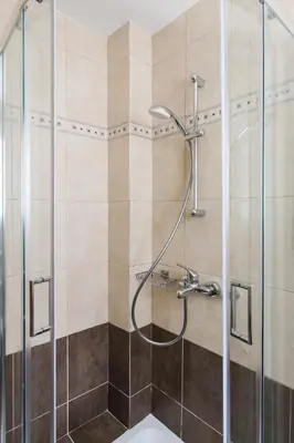 a shower with a glass door in a bathroom at Delightful 1BD Apartment in Plaka by UPSTREET in Athens