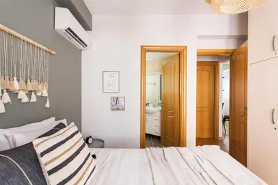 a bedroom with a bed and a bathroom at Delightful 1BD Apartment in Plaka by UPSTREET in Athens