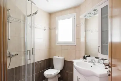 a bathroom with a toilet and a sink and a shower at Delightful 1BD Apartment in Plaka by UPSTREET in Athens
