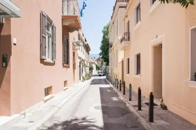 an empty street in an alley between two buildings at Delightful 1BD Apartment in Plaka by UPSTREET in Athens