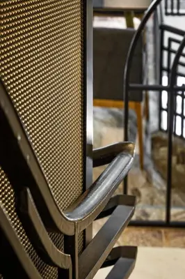 a metal chair sitting next to a table at Athenian Foss in Athens