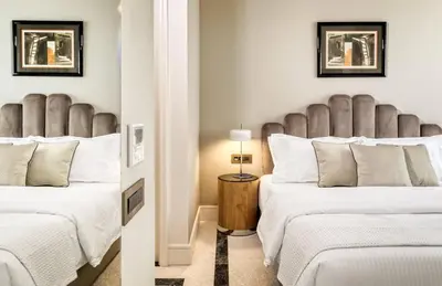 a bedroom with two beds with white sheets at Athenian Foss in Athens