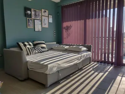 a bedroom with a bed and a large window at Elegant Bright Apartment with Acropolis view terrace in Athens