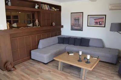 a living room with a couch and a coffee table at METROPOLITAN MACVIEW Διαμέρισμα in Piraeus