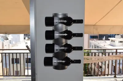 a group of wine bottles on the side of a building at METROPOLITAN MACVIEW Διαμέρισμα in Piraeus