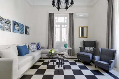 a living room with a couch and two chairs at The Gem of Filopappou in Athens