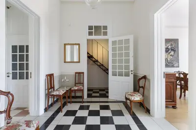 a hallway with a staircase and a table and chairs at The Gem of Filopappou in Athens