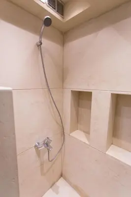 a shower with a shower head in a bathroom at Plaka360 Apartments in Athens