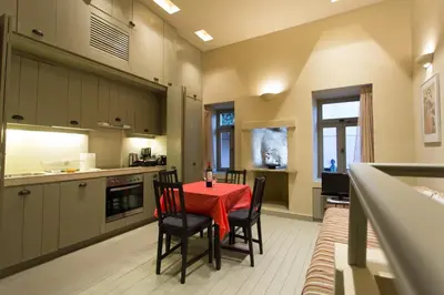 a kitchen with a red table and chairs in it at Plaka360 Apartments in Athens