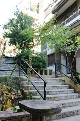 a set of stairs in front of a building with a table at Athenian Hub Luxe Loft in Athens