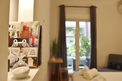 a clock on a counter in a room with a window at Athenian Hub Luxe Loft in Athens