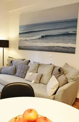 a living room with a couch and a picture of the ocean at Athenian Hub Luxe Loft in Athens