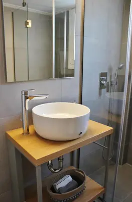 a bathroom with a white sink and a shower at Athenian Hub Luxe Loft in Athens