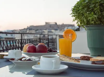 a table with breakfast food and a glass of orange juice at Elegance in Athens in Athens