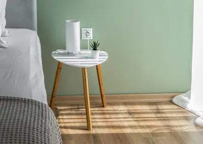 a table with a plant on it next to a bed at Elegance in Athens in Athens