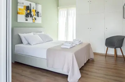 a bedroom with a bed with a table and a chair at Elegance in Athens in Athens