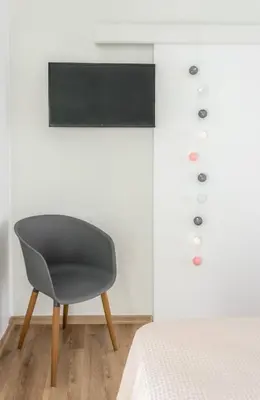a bedroom with a chair next to a bed at Elegance in Athens in Athens