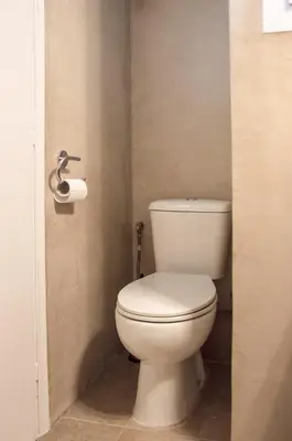 a bathroom with a toilet and a roll of toilet paper at Elegance in Athens in Athens